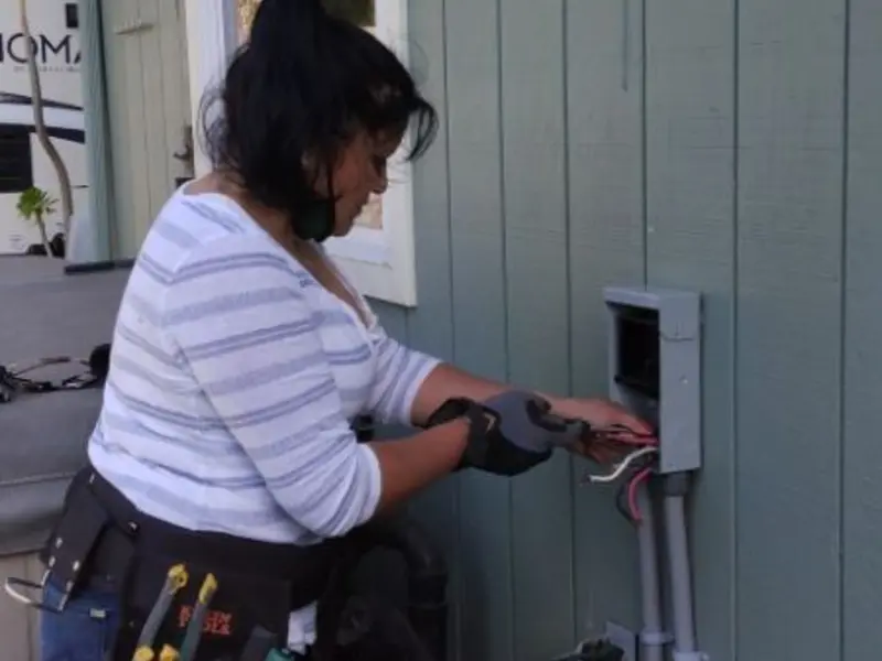 Licensed electrician wiring an exterior subpanel in Arcola