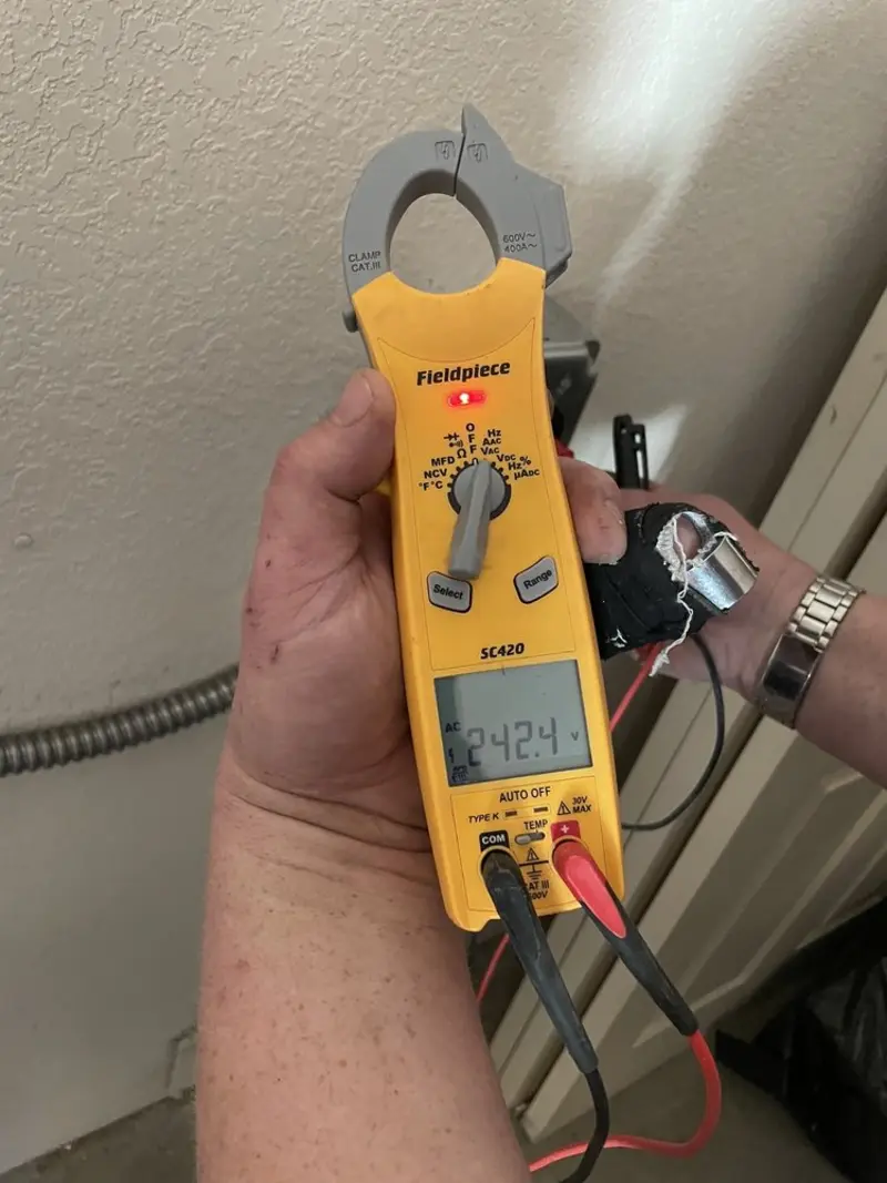 Voltage testing with clamp meter during Ceiling Fan Installation in Arcola